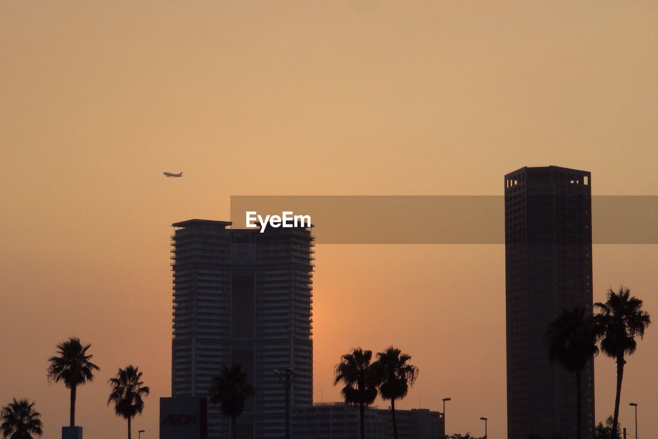 Low angle view of buildings against sky at sunset