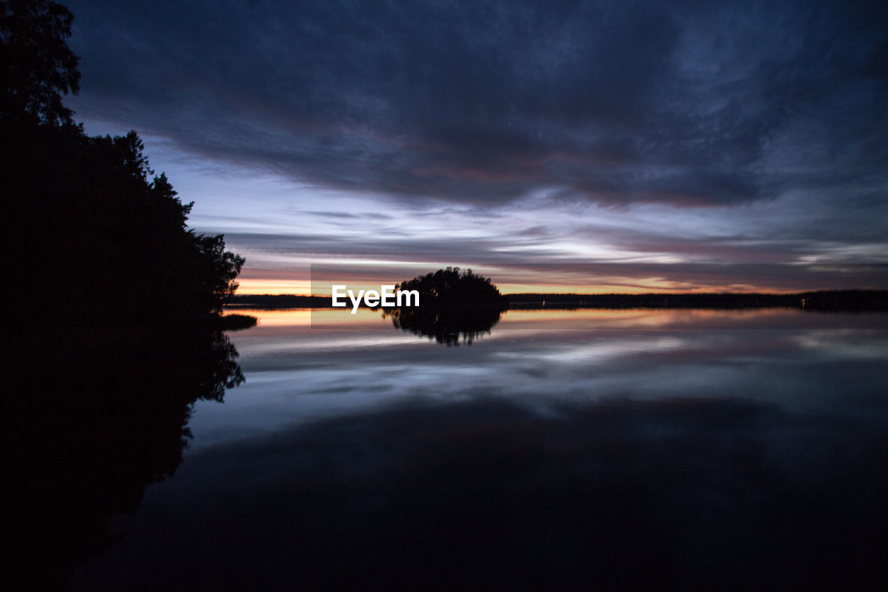 SUNSET OVER CALM LAKE