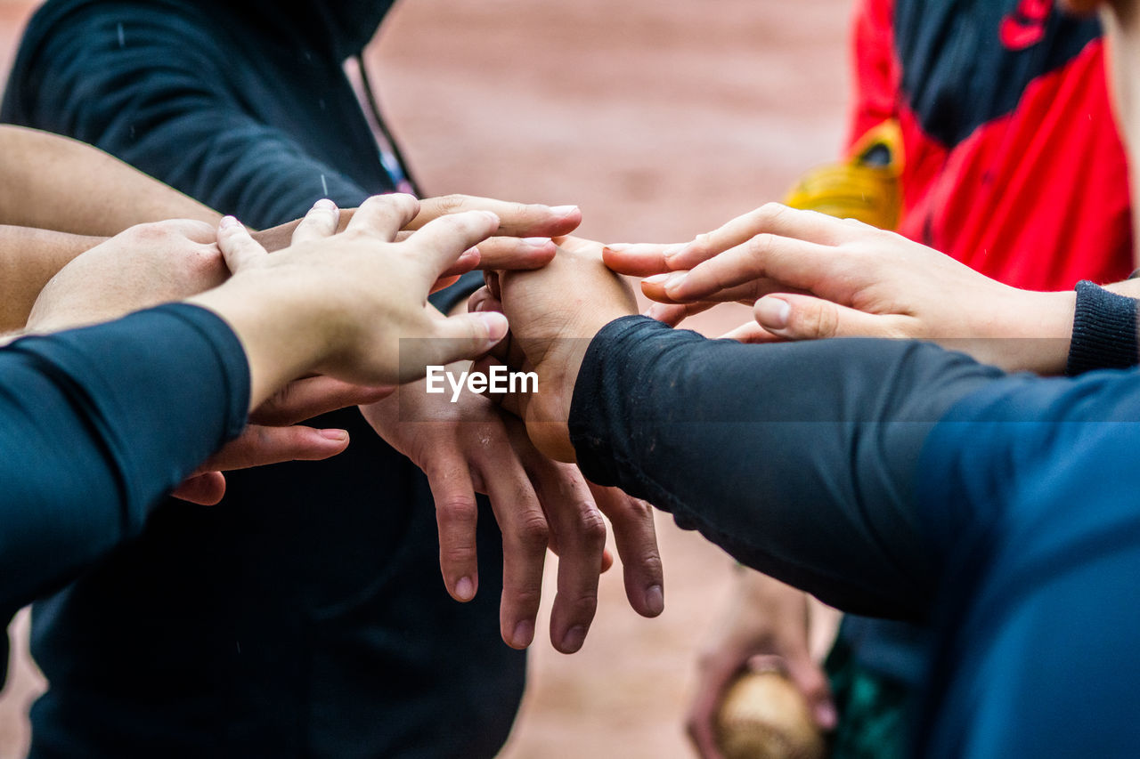 Friends stacking hands outdoors