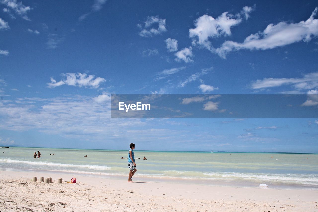 Boy walking at beach