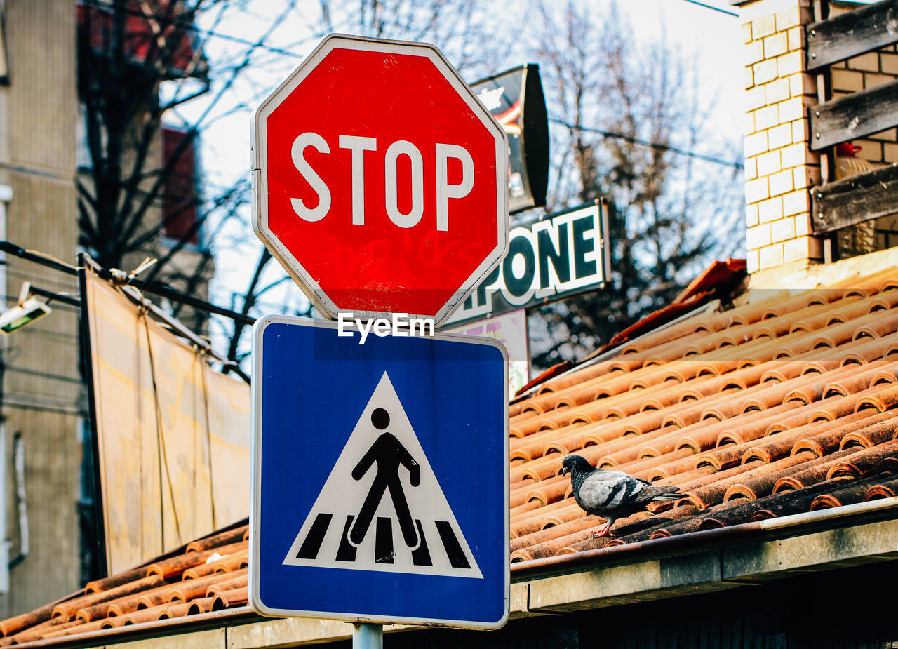 Road sign against built structure