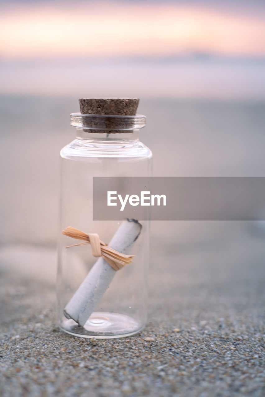 close-up of bottle in jar on table