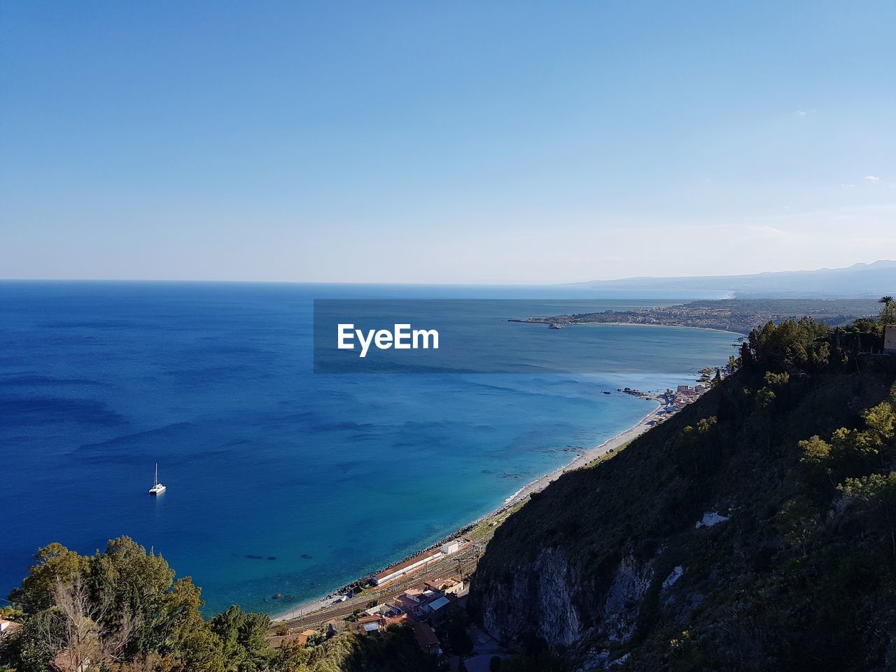 Scenic view of sea against clear blue sky