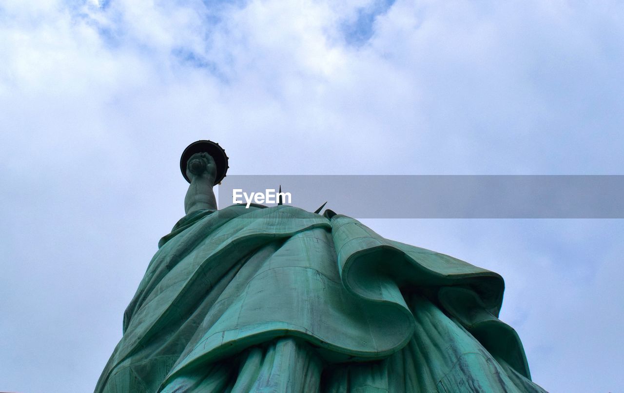 Statue of liberty against cloudy sky