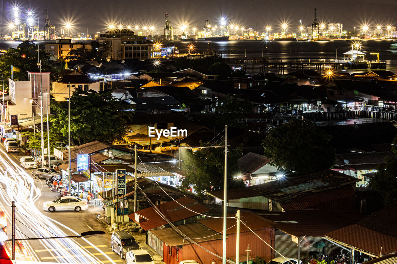 HIGH ANGLE VIEW OF ILLUMINATED BUILDINGS AT NIGHT