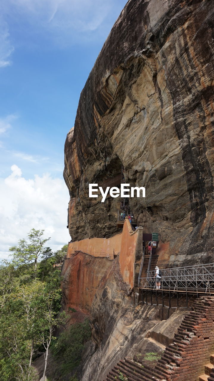 Low angle view of rock formation against sky