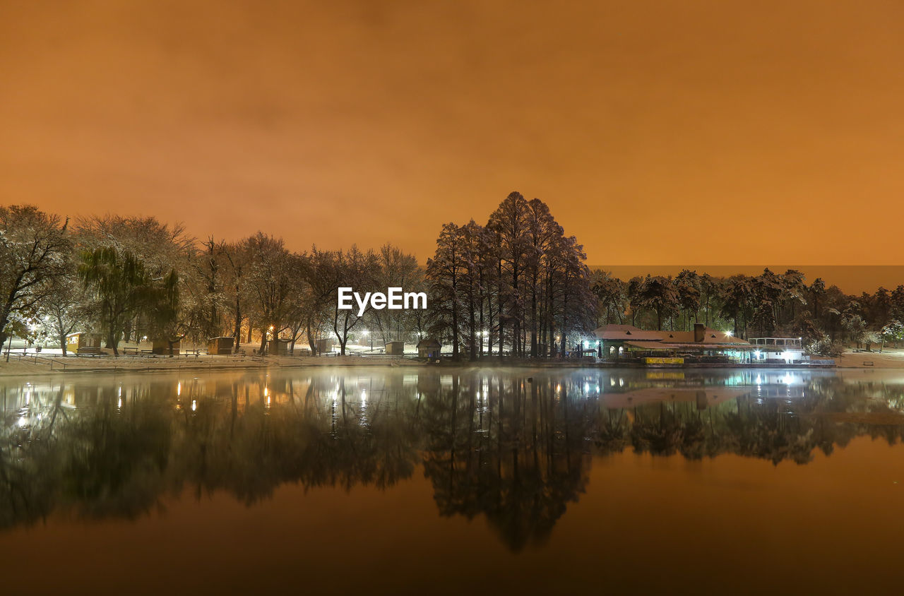 Scenic view of lake against sky at sunset