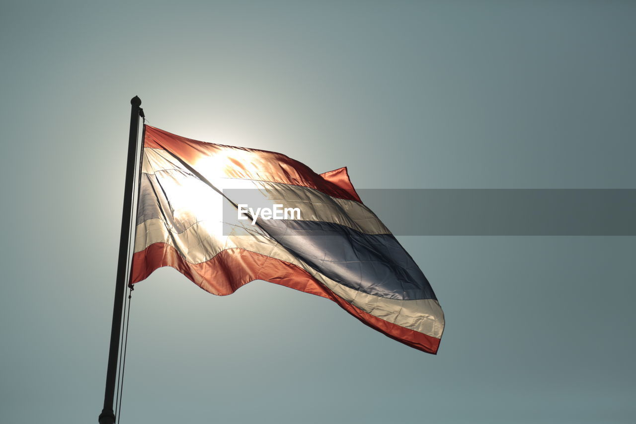 Low angle view of flag against clear sky