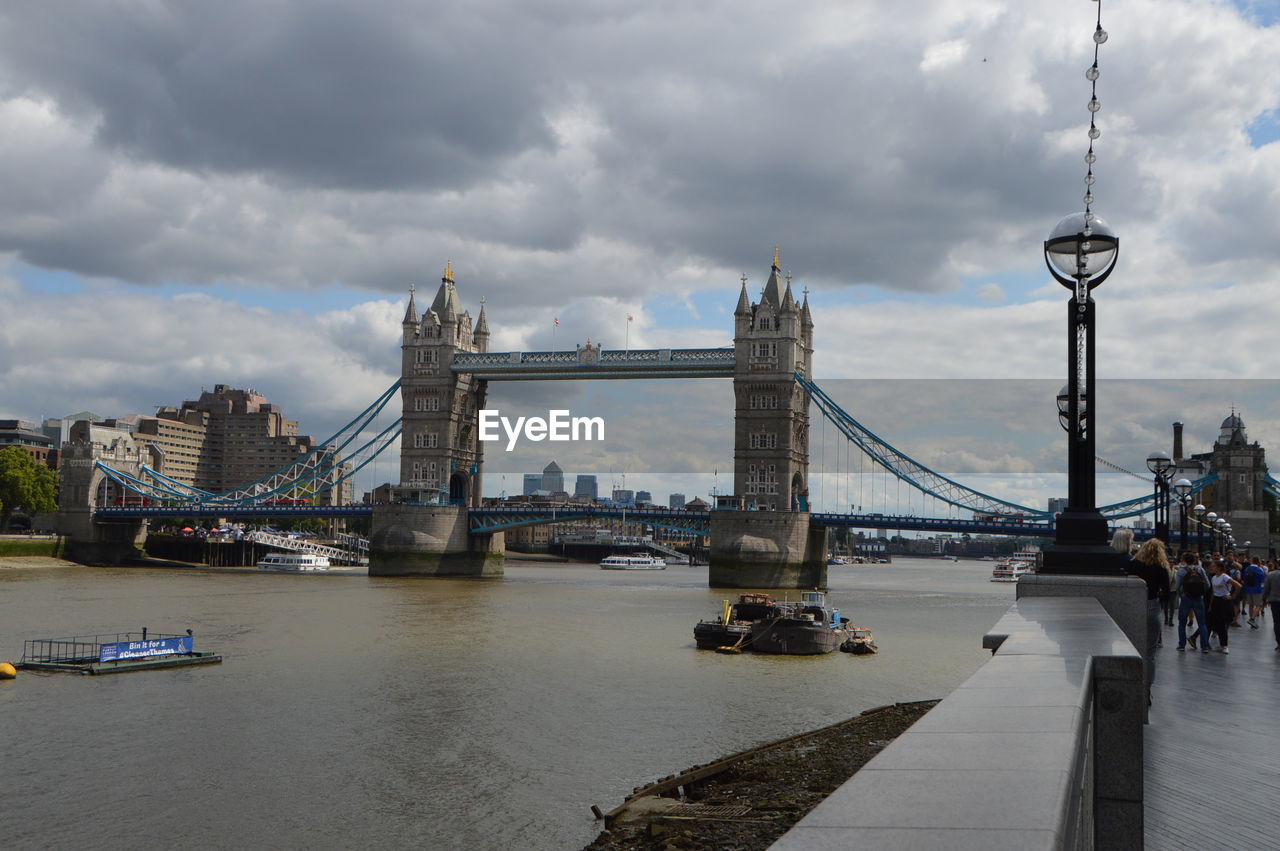 View of tower bridge over river against cloudy sky.