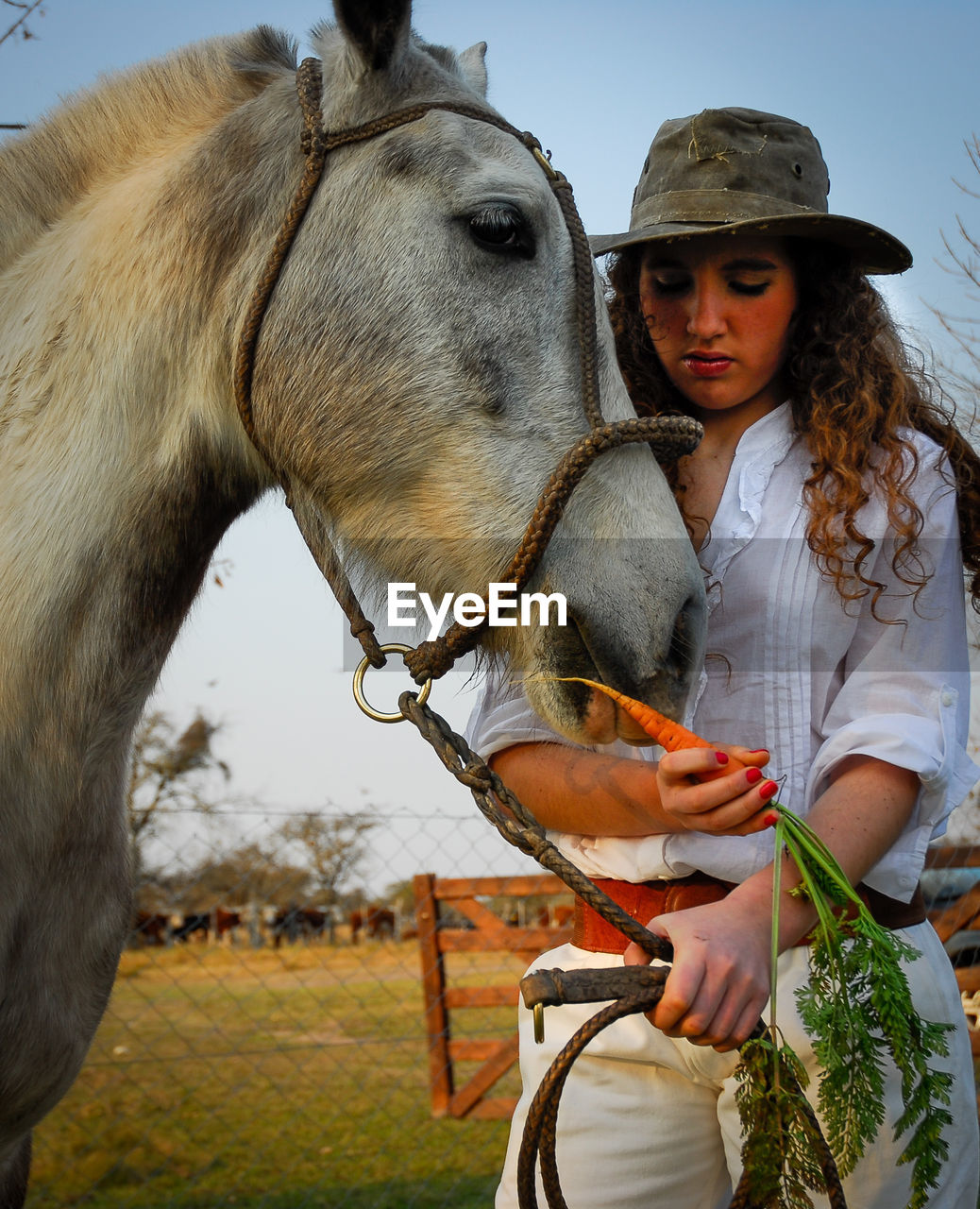 PORTRAIT OF WOMAN WITH HORSE