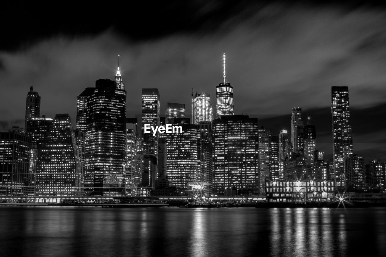 Illuminated new york cityscape against sky at night