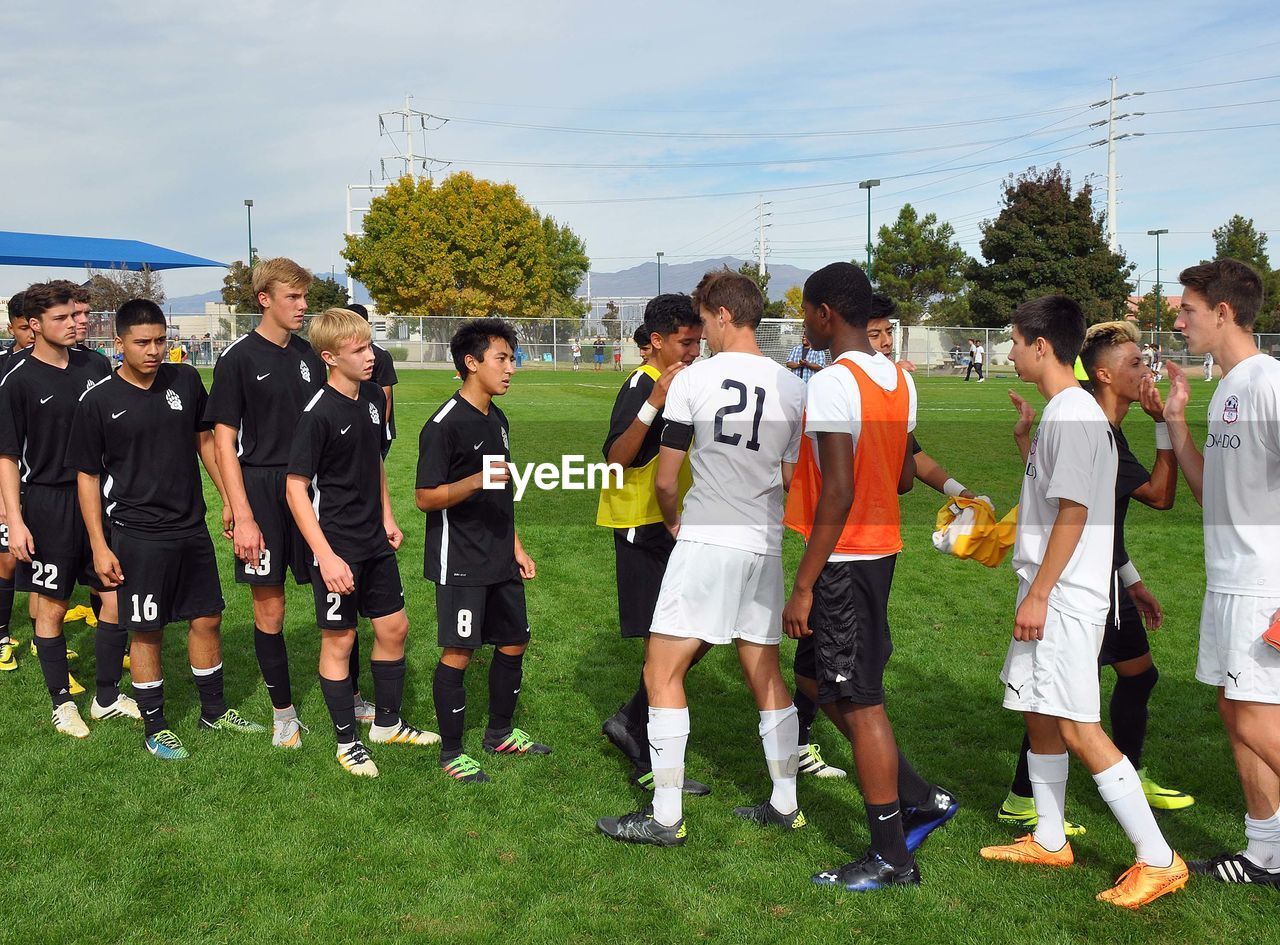 GROUP OF PEOPLE ON SOCCER FIELD