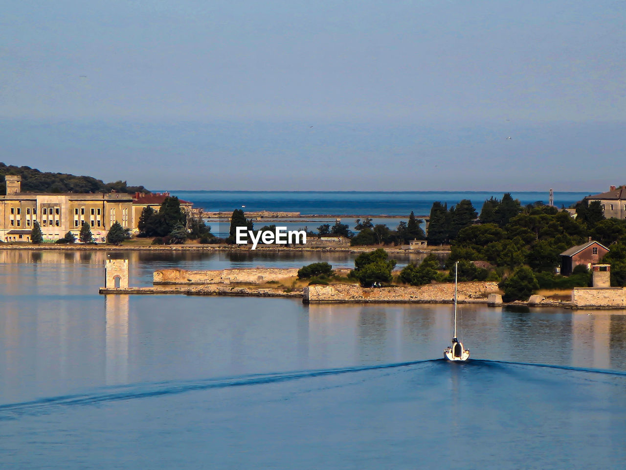 Boat leaving the port of pula early in the morning