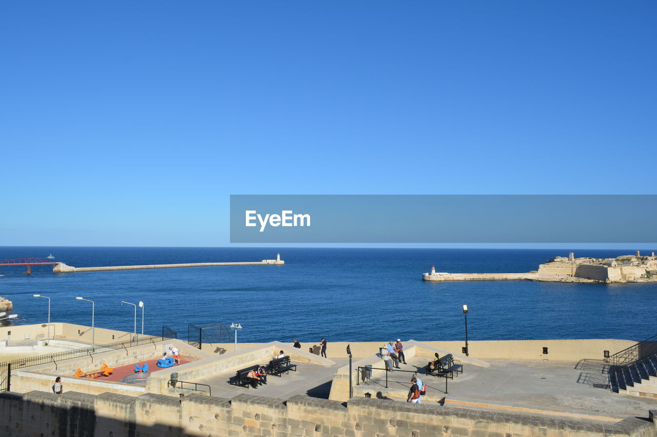 HIGH ANGLE VIEW OF CITY AT SEASIDE