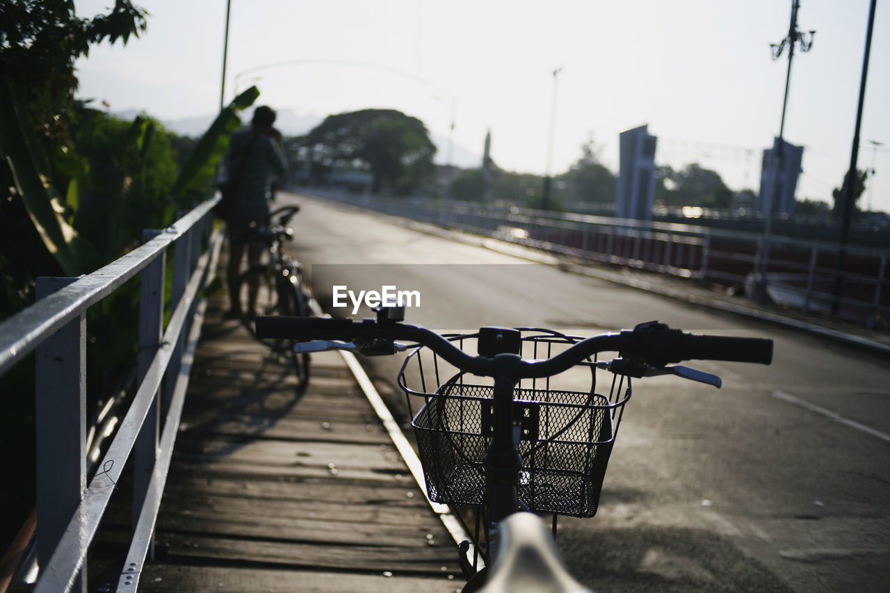 BICYCLE ON BRIDGE AGAINST SKY