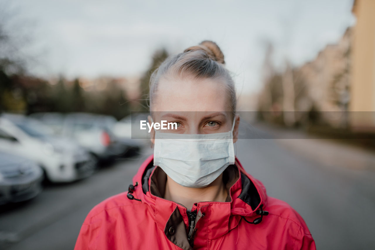 Portrait of woman wearing mask in city