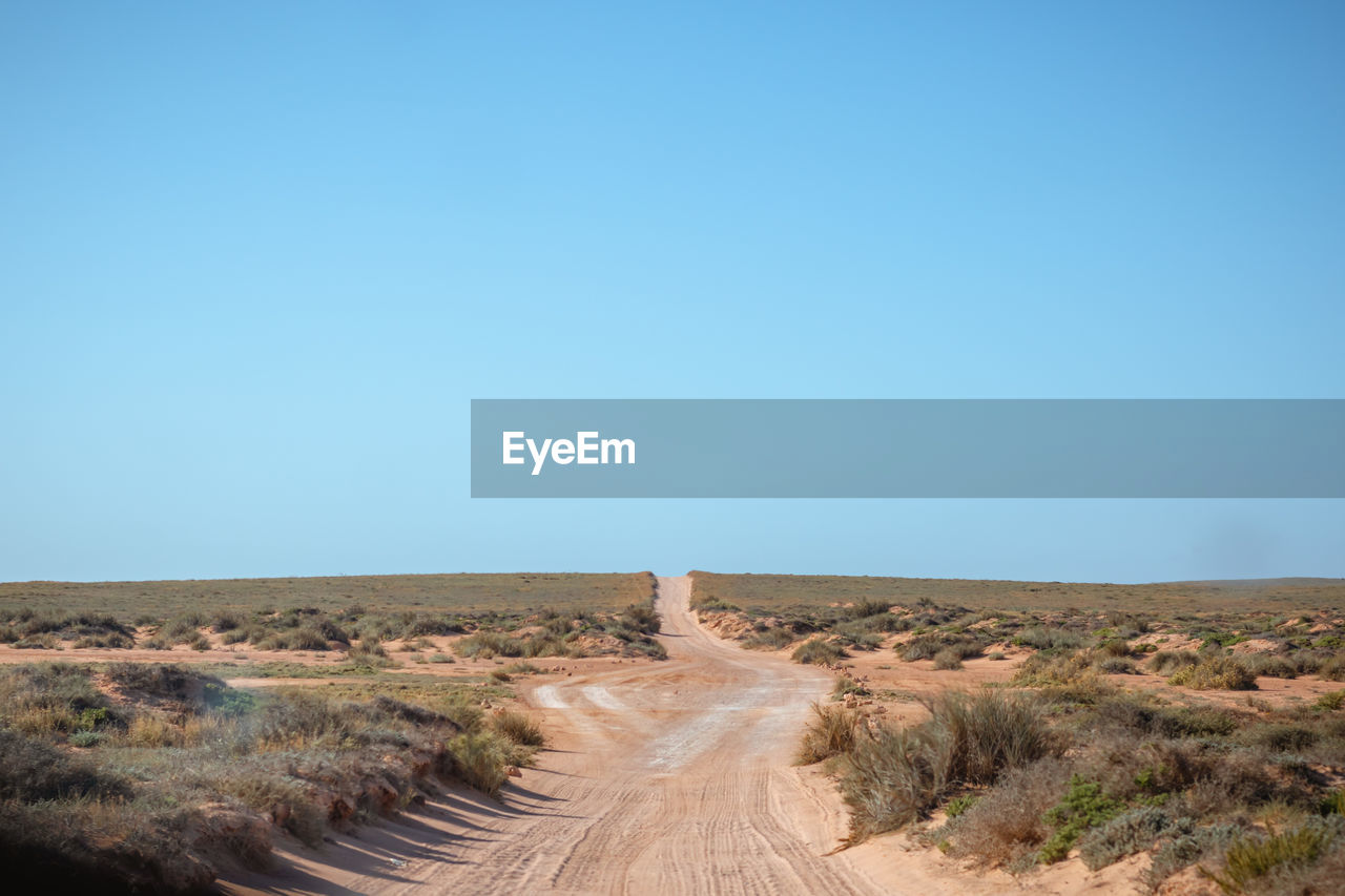 Dirt road passing through a desert