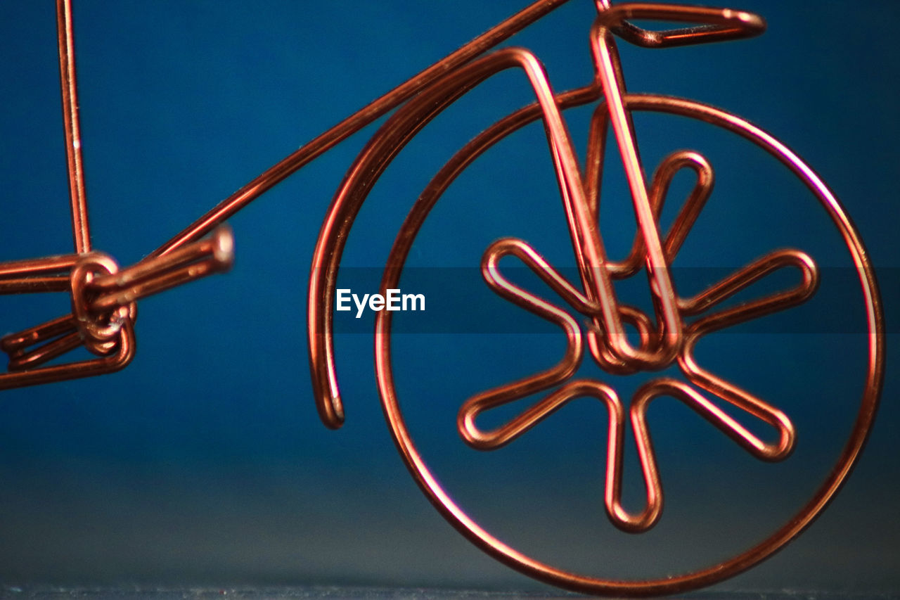 Close up of a wheel made from copper wire 