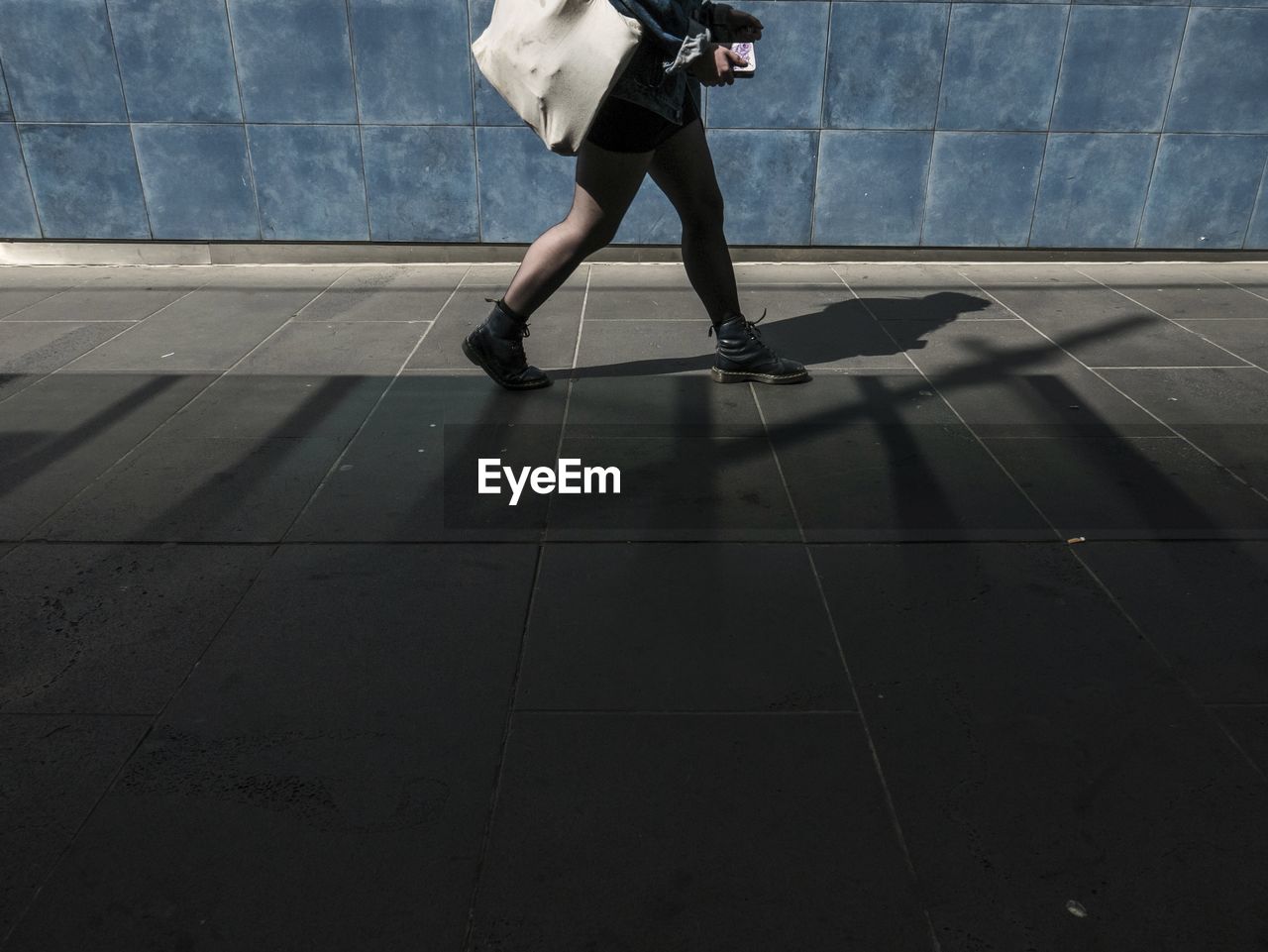 Low section of person walking on street