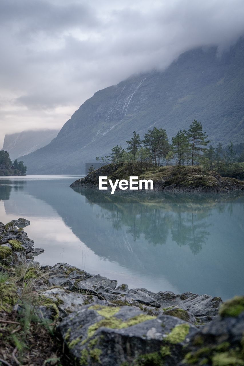 Scenic view of lake and mountains against sky