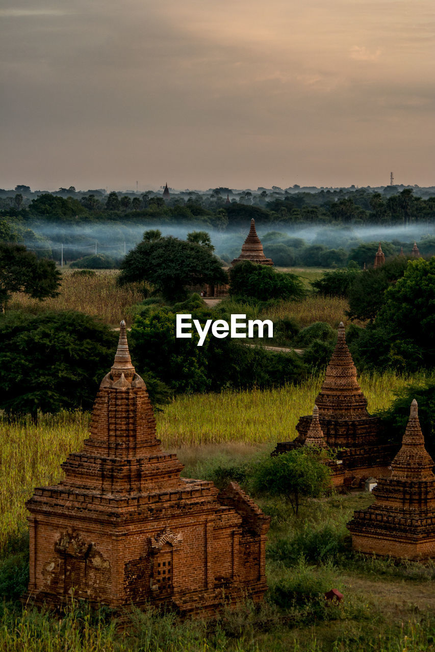 Old buddhist temples against sky during sunset