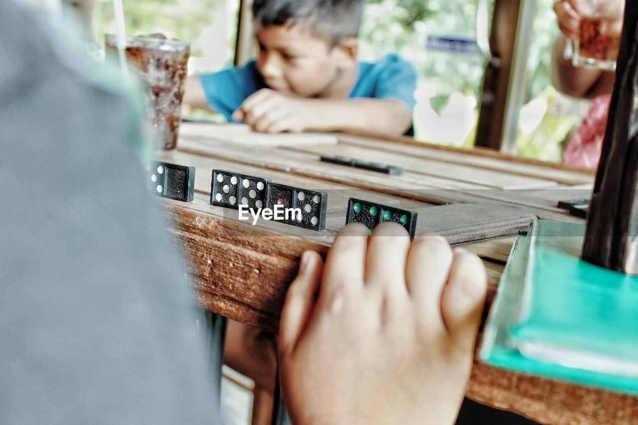 People playing domino on table