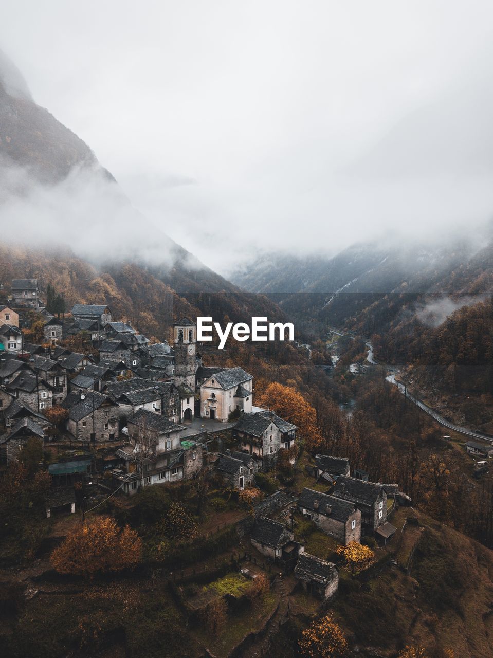 High angle view of town on mountain during foggy weather