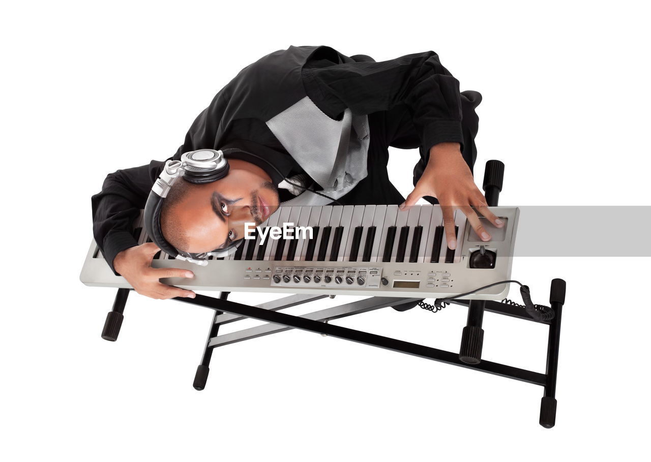 piano, musical instrument, one person, musical keyboard, white background, keyboard, adult, music, electronic instrument, cut out, arts culture and entertainment, studio shot, person, men, indoors, musical equipment, young adult, musician, sitting, black, full length, portrait, occupation, lifestyles