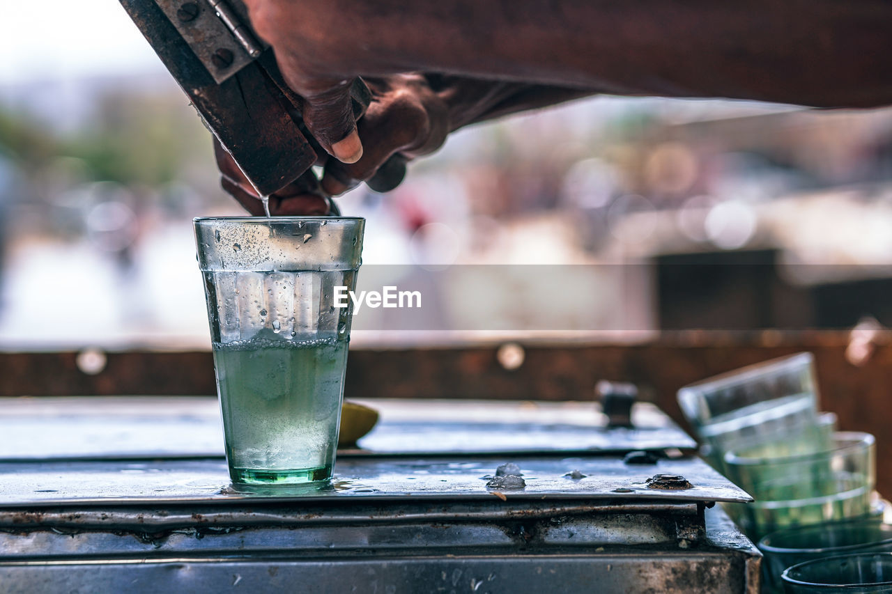 Cropped hands making drink