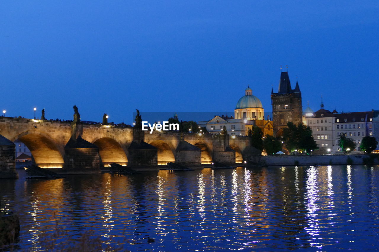 VIEW OF ILLUMINATED BUILDINGS AT RIVERBANK