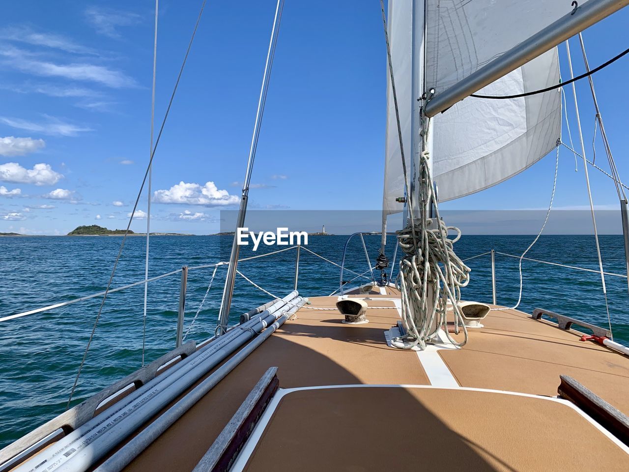 Sailboat sailing in sea against sky