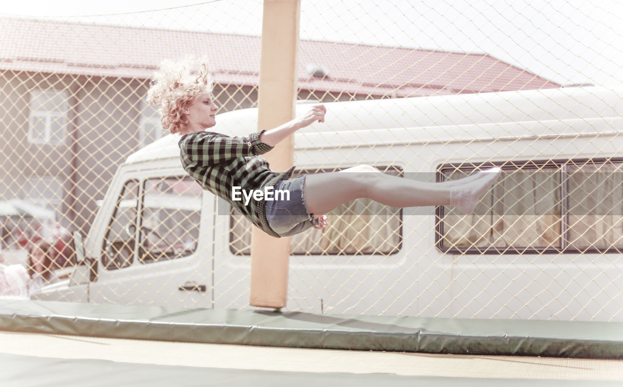 Young woman jumping on trampoline