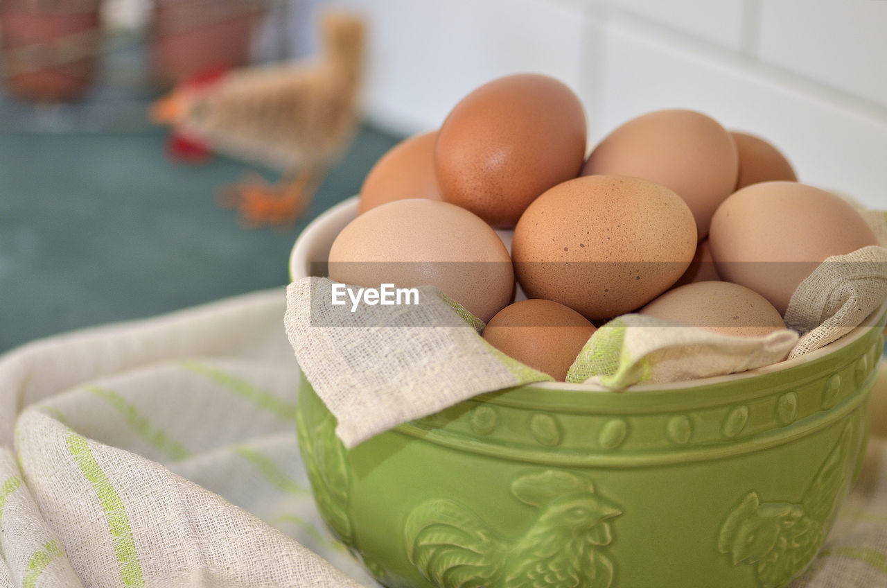 Close-up of brown eggs in bowl on table