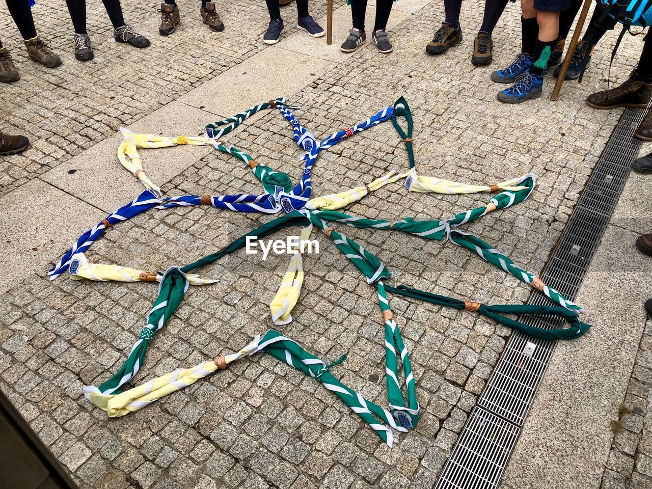 HIGH ANGLE VIEW OF FISHING NET ON METAL FOOTPATH