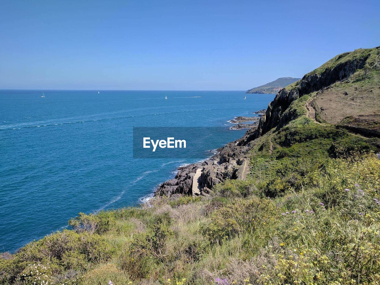 Scenic view of sea against blue sky