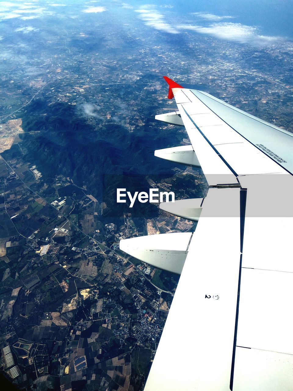 AERIAL VIEW OF AIRPLANE WING OVER LANDSCAPE