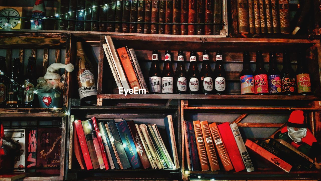 Books and bottles in shelves at store