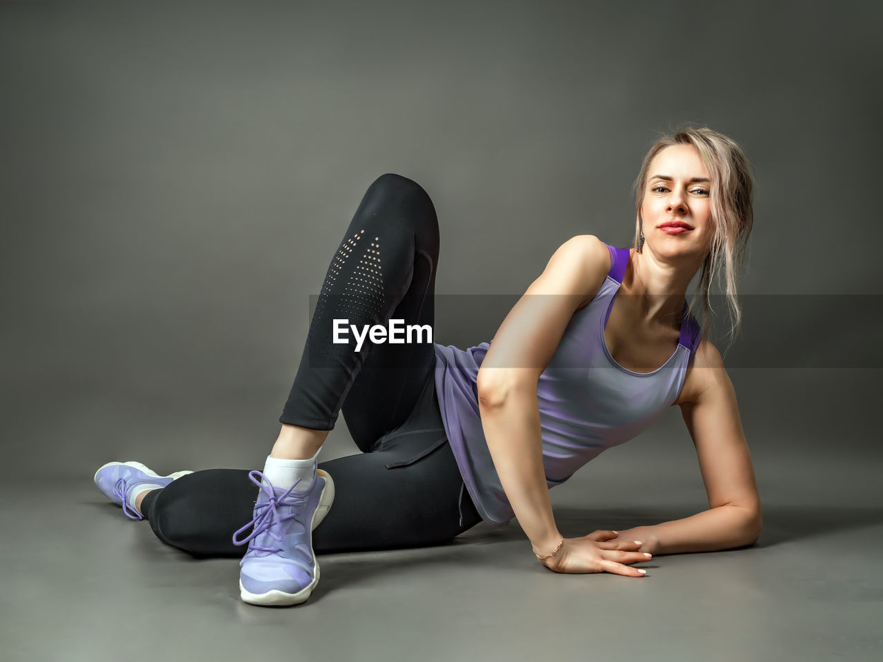 Sportswear girl is engaged fitness. stretching of her legs.