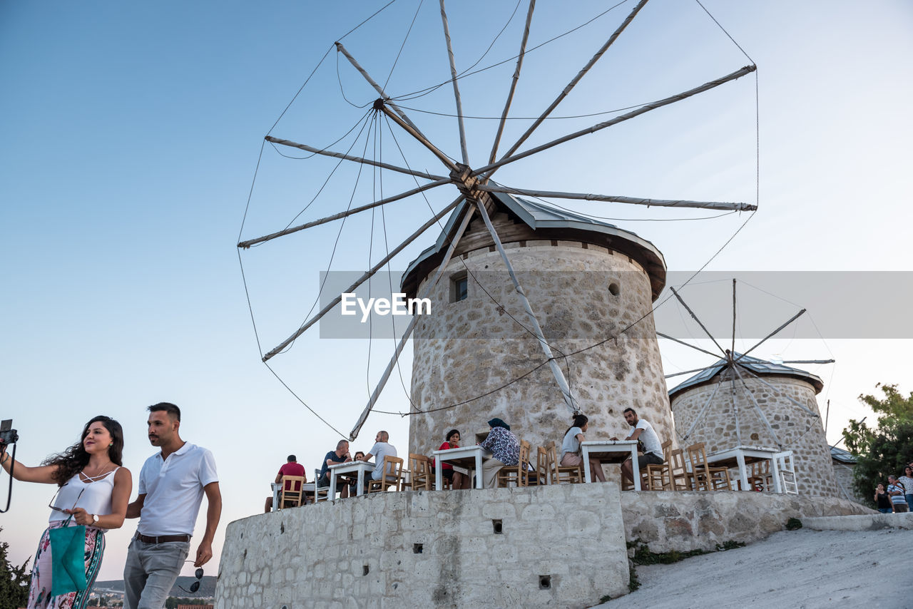 LOW ANGLE VIEW OF TRADITIONAL WINDMILL AGAINST SKY