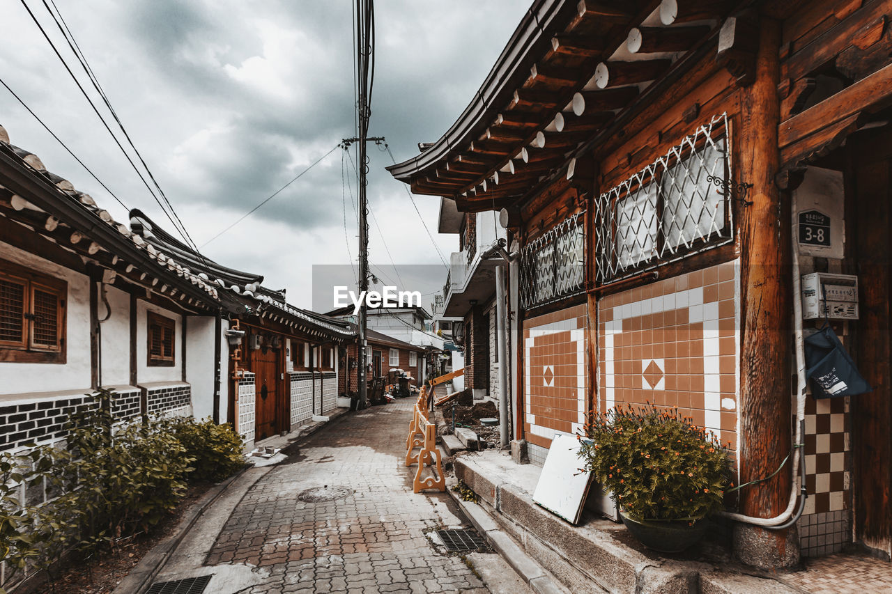 Street amidst buildings against sky