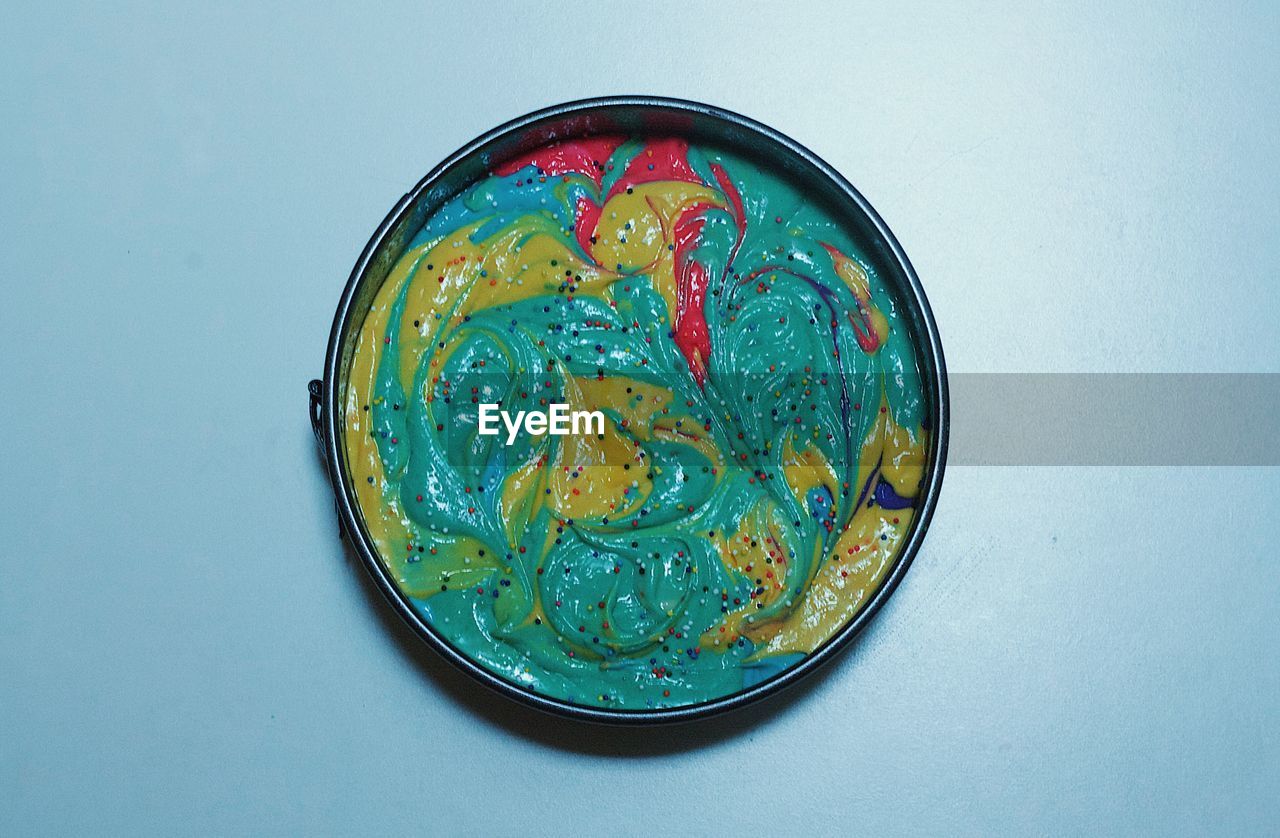 High angle view of multi colored food in bowl on table