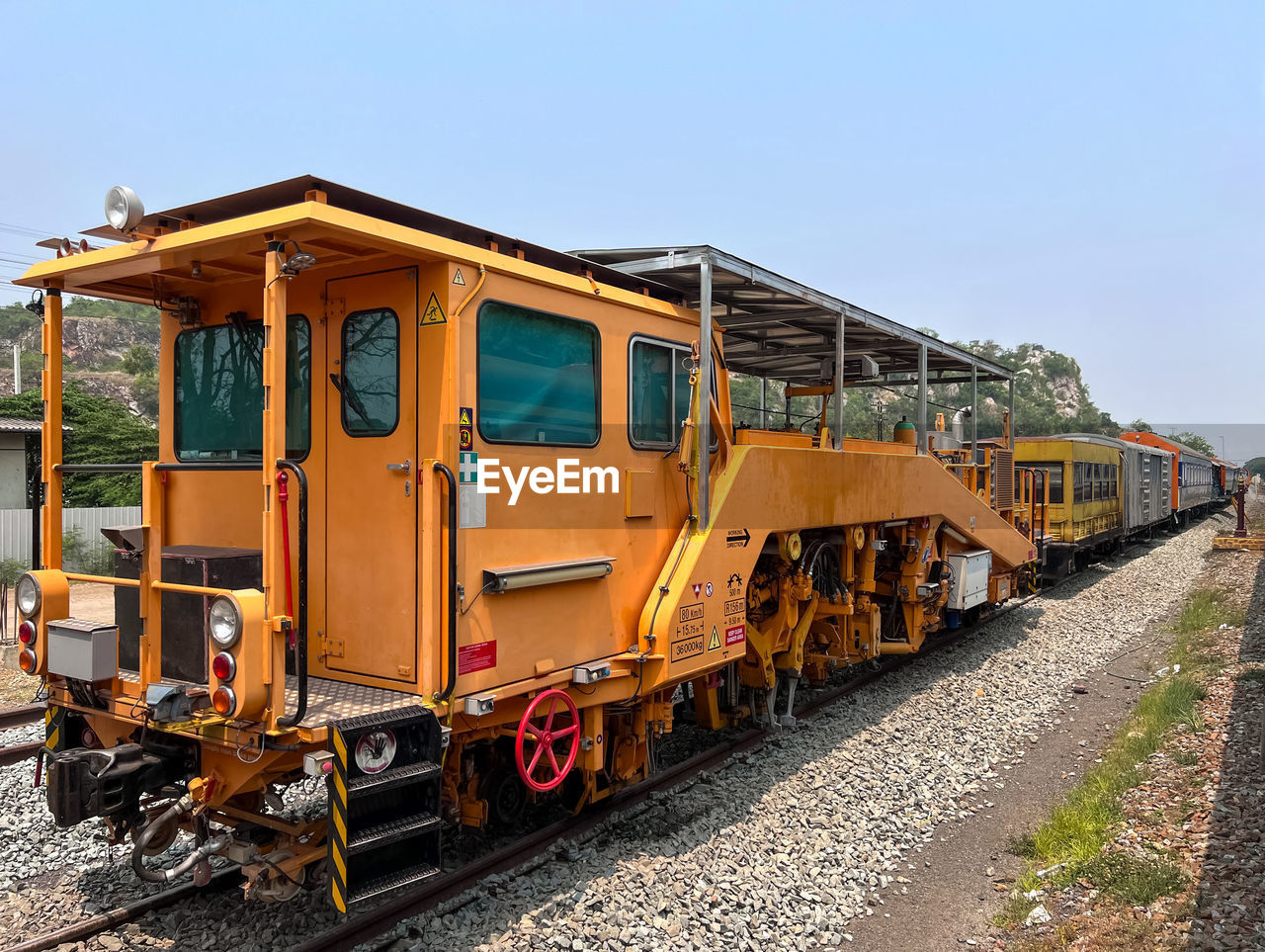 The ballast tamping machine is parking after works to maintain the sleeper and ballast stone.