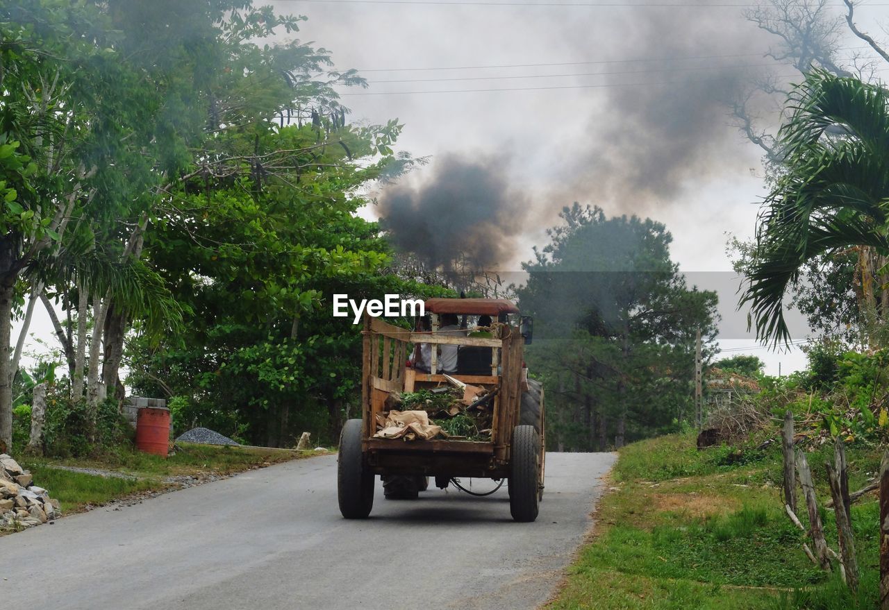 Tractor on street against sky