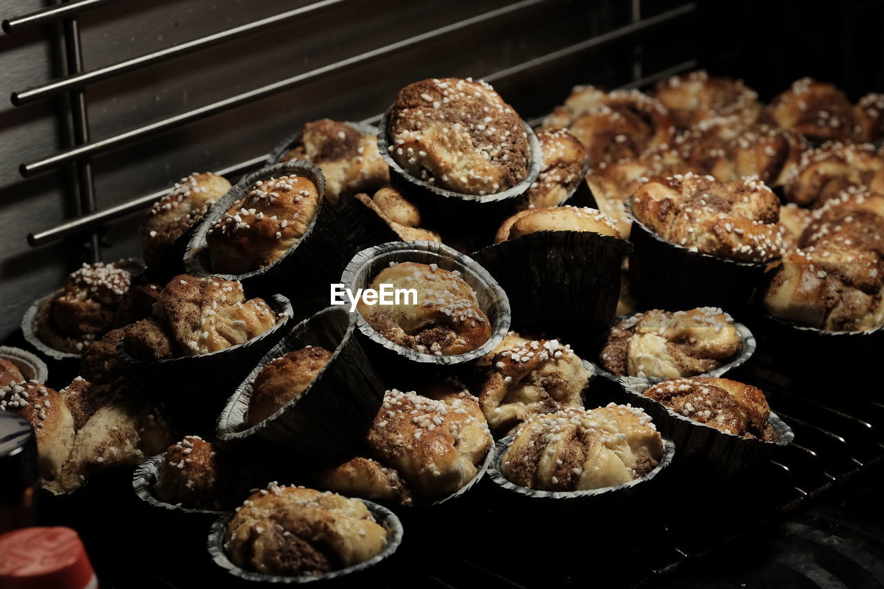 Heap of cinnamon rolls in containers