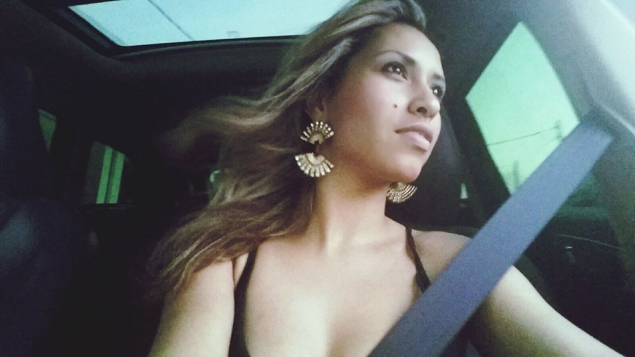 Beautiful woman sitting in car