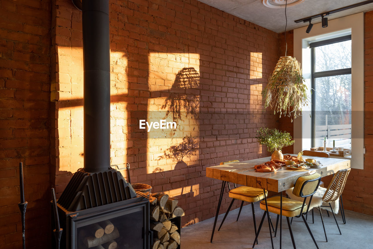 CHAIRS AND TABLE AGAINST WALL AT HOME