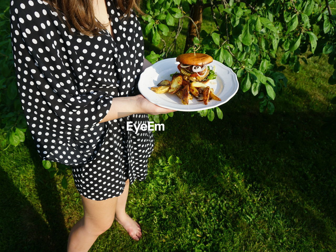 High angle view of woman holding food in plate