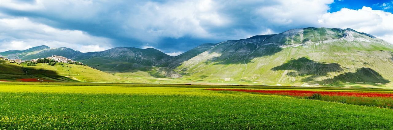 Panoramic view of green mountain landscape against sky