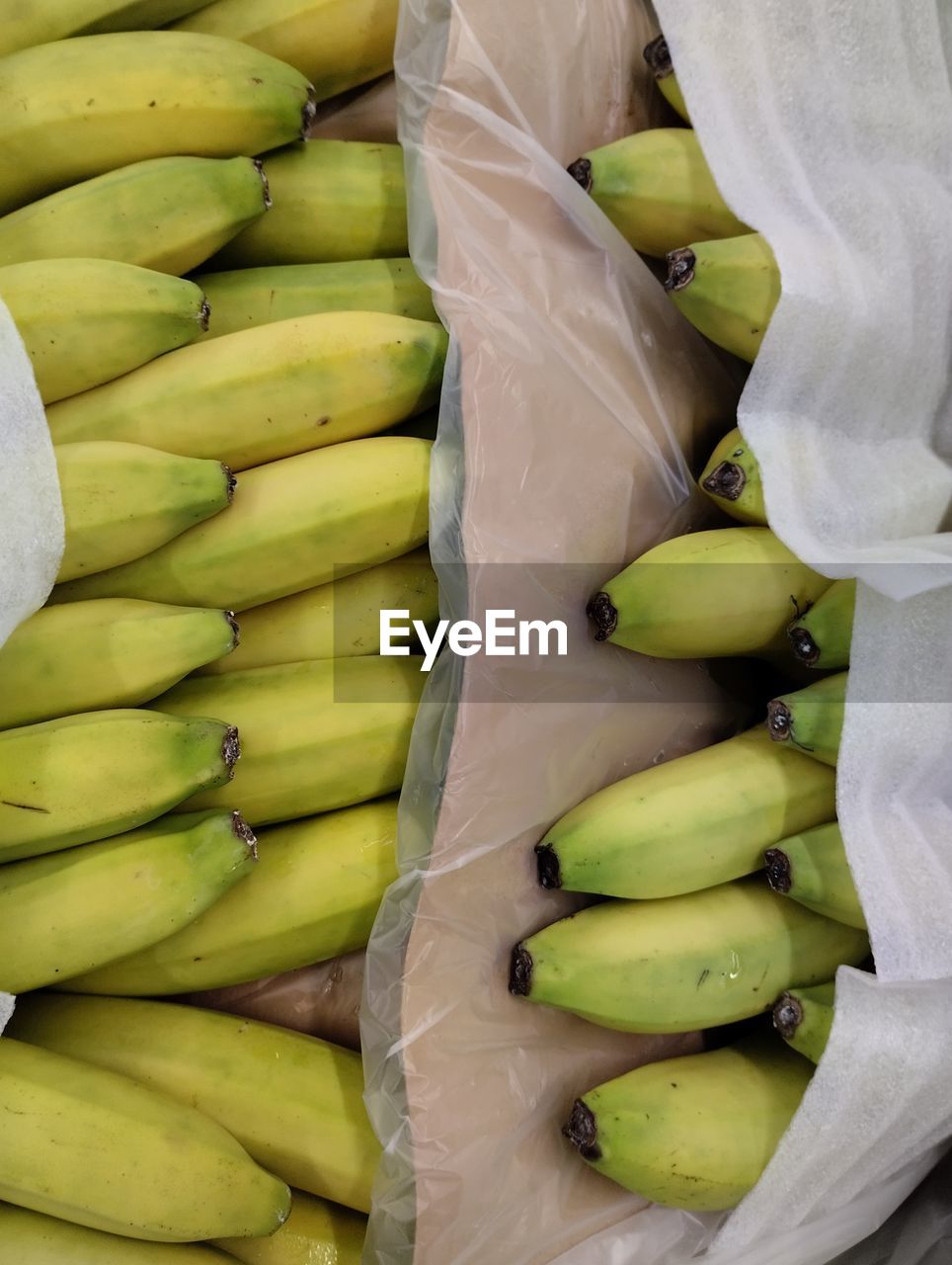 food, food and drink, healthy eating, freshness, wellbeing, fruit, produce, banana, plant, no people, retail, high angle view, market, green, yellow, abundance, large group of objects, still life, organic, business finance and industry, vegetable, for sale, close-up, full frame, business