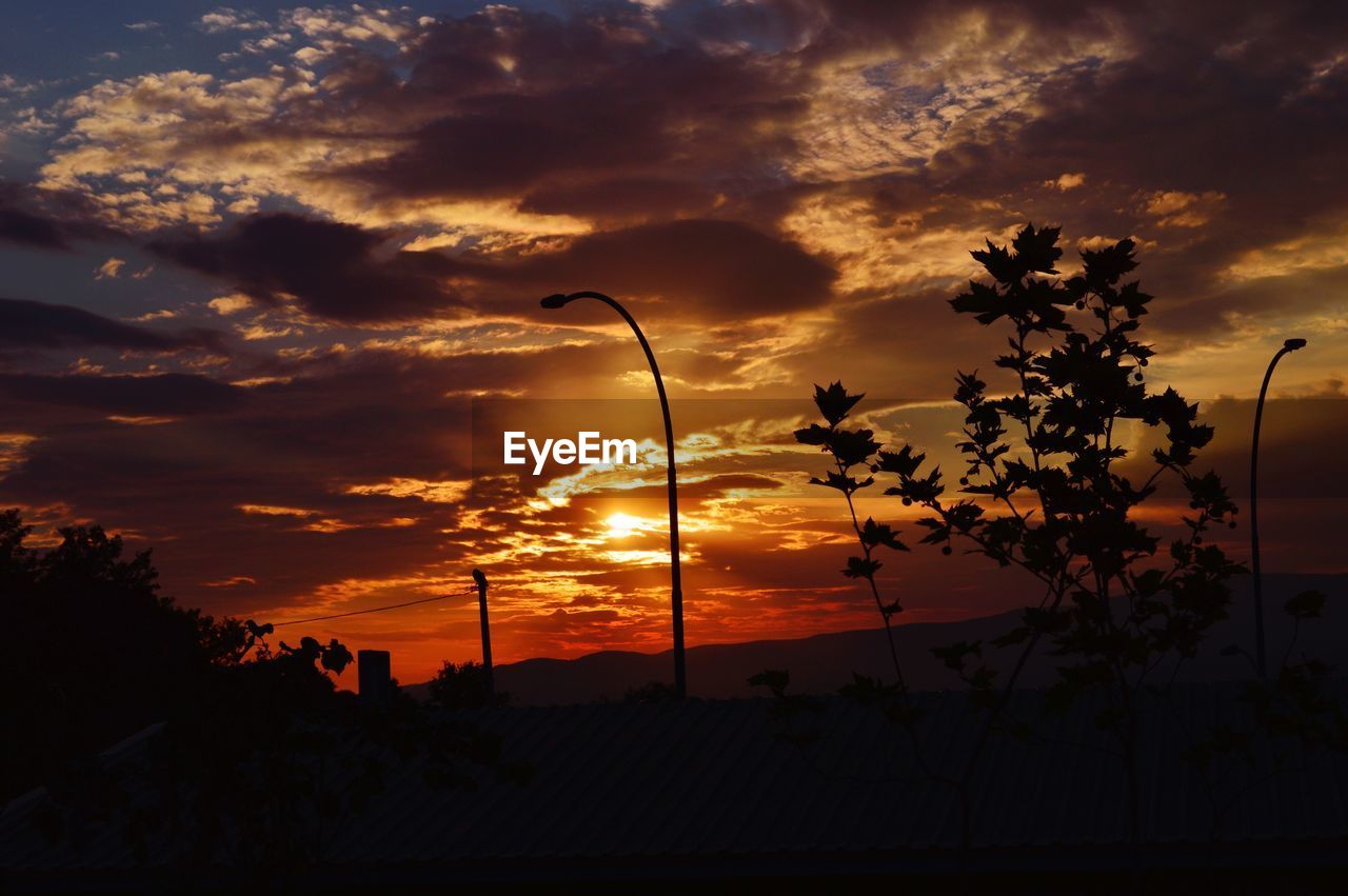 SCENIC VIEW OF SILHOUETTE LANDSCAPE AGAINST ORANGE SKY